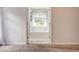 Bright bathroom showcasing a tub under a window with natural light and white sheer curtains at 5025 Bishops Row Row, Austell, GA 30106