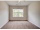 Bedroom featuring neutral walls, carpet, and a large window providing natural light at 5025 Bishops Row Row, Austell, GA 30106