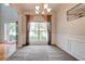 Open floor plan dining room has a chandelier, wainscoting, and bright natural light at 5025 Bishops Row Row, Austell, GA 30106