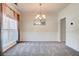 Bright dining room with neutral carpet, wainscoting, chandelier, and large window at 5025 Bishops Row Row, Austell, GA 30106