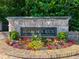 Well-maintained brick entrance sign for Bishop's Run Est. 2004 surrounded by colorful flowers and greenery at 5025 Bishops Row Row, Austell, GA 30106