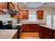 Kitchen features granite counters, stainless appliances, wood cabinets, and island at 5025 Bishops Row Row, Austell, GA 30106
