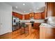 View of the kitchen with dark wood cabinets, island with seating, and stainless appliances at 5025 Bishops Row Row, Austell, GA 30106