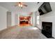 Spacious living room seamlessly connecting to the kitchen, with a fireplace and bright natural lighting at 5025 Bishops Row Row, Austell, GA 30106
