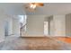 Open-concept living area with plush carpet and an open staircase creating a sense of spaciousness at 5025 Bishops Row Row, Austell, GA 30106