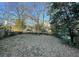 View of the home's spacious fenced backyard with mature trees and room for recreation at 535 Walnut St, Hapeville, GA 30354