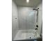 Elegant bathroom with a tub/shower combo featuring a black shower head and glass door at 535 Walnut St, Hapeville, GA 30354