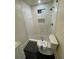 Well-lit bathroom showcasing new shower tiles and hardware, with a complementary toilet and a tiled shower floor at 535 Walnut St, Hapeville, GA 30354