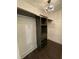 Walk-in closet features built-in shelving and a decorative chandelier, providing ample storage with style at 535 Walnut St, Hapeville, GA 30354