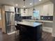 Modern kitchen with stainless steel appliances, island with bar stools, and ample counter space at 535 Walnut St, Hapeville, GA 30354