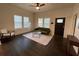 Bright living room with hardwood floors, large windows, ceiling fan, and comfortable seating at 535 Walnut St, Hapeville, GA 30354