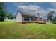 A view of the back of the home and backyard at 555 Flintlock Dr, Dacula, GA 30019