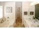 Bathroom featuring a tub, double vanity, and tile floors at 555 Flintlock Dr, Dacula, GA 30019