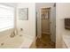 Bathroom featuring a tub, double vanity, and tile floors at 555 Flintlock Dr, Dacula, GA 30019