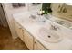 Bright bathroom featuring double sinks, white countertops, and neutral-colored cabinetry at 555 Flintlock Dr, Dacula, GA 30019