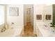Bathroom featuring a tub, double vanity, and tile floors at 555 Flintlock Dr, Dacula, GA 30019