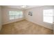 Spacious bedroom featuring neutral carpet, ceiling fan, and ample natural light at 555 Flintlock Dr, Dacula, GA 30019