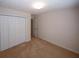 Bedroom featuring carpeted floors, closet, and door leading to another room at 555 Flintlock Dr, Dacula, GA 30019