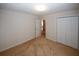 Carpeted bedroom featuring a closet and doorway to another room or hall at 555 Flintlock Dr, Dacula, GA 30019