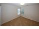 Bedroom showcasing neutral walls, carpeted flooring, and natural light from a window at 555 Flintlock Dr, Dacula, GA 30019