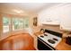 The kitchen is set next to a breakfast nook with floor to ceiling windows and outdoor views at 555 Flintlock Dr, Dacula, GA 30019