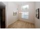 Dining room featuring a chandelier, large windows, and neutral carpet at 555 Flintlock Dr, Dacula, GA 30019