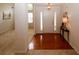 Inviting foyer with hardwood floors, adjacent to a carpeted room and featuring a hall table at 555 Flintlock Dr, Dacula, GA 30019