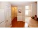 The kitchen and entryway feature warm wood floors, white trim, and an open floor plan at 555 Flintlock Dr, Dacula, GA 30019