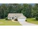An aerial view of the home showing mature landscaping, grassy yard, and inviting entrance at 555 Flintlock Dr, Dacula, GA 30019