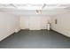 Clean garage with painted floor, water heater, and access to the home at 555 Flintlock Dr, Dacula, GA 30019