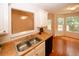 The kitchen features an open floor plan, a double sink, and a view into a dining area at 555 Flintlock Dr, Dacula, GA 30019