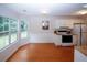 Bright kitchen with white cabinets, stainless steel appliances, and adjacent breakfast area at 555 Flintlock Dr, Dacula, GA 30019