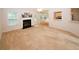 Open living room featuring a fireplace and a view to the kitchen at 555 Flintlock Dr, Dacula, GA 30019