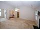 Bright living room with vaulted ceilings, a ceiling fan, and neutral carpeting at 555 Flintlock Dr, Dacula, GA 30019