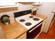 The white stove is set into warm countertops and cabinets in this kitchen at 555 Flintlock Dr, Dacula, GA 30019