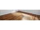 Hardwood flooring with wood paneled walls and white trim at 138 Woodlawn Ave, Decatur, GA 30030