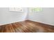 Clean and vacant bedroom with hardwood floors, two windows, and white walls at 138 Woodlawn Ave, Decatur, GA 30030