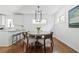 Stylish dining room with modern light fixture and wood flooring at 138 Woodlawn Ave, Decatur, GA 30030
