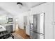 Modern kitchen with stainless steel refrigerator and appliances plus white cabinets and hardwood floors at 138 Woodlawn Ave, Decatur, GA 30030