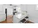 Modern kitchen with white cabinets, stainless steel appliances, and breakfast bar at 138 Woodlawn Ave, Decatur, GA 30030