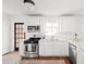 Bright kitchen featuring white cabinetry, stainless steel appliances, and tiled backsplash at 138 Woodlawn Ave, Decatur, GA 30030