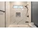 Elegant bathroom with white marble tiles, black fixtures, and a built in shower seat at 205 Maple St, Atlanta, GA 30354
