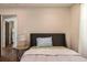 Inviting bedroom with hardwood flooring, a side table, and a comfortable bed with neutral decor at 205 Maple St, Atlanta, GA 30354
