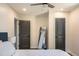 Comfortable bedroom features two gray doors, a full length mirror, and a bed with striped bedding at 205 Maple St, Atlanta, GA 30354