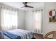 Serene bedroom with a ceiling fan, bright windows, and a comfy bed with striped covers and natural decor at 205 Maple St, Atlanta, GA 30354