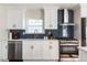 Modern kitchen featuring white cabinets, stainless steel appliances, and stylish backsplash at 205 Maple St, Atlanta, GA 30354