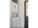Stacked white washer and dryer setup is conveniently tucked near a door at 205 Maple St, Atlanta, GA 30354