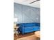 Living area with modern decor, including a plush blue sofa and textured wall at 205 Maple St, Atlanta, GA 30354