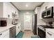 Well-lit kitchen featuring white cabinets, stainless steel appliances, and tiled backsplash at 3198 Oakdale Rd, Atlanta, GA 30354