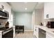 Modern kitchen with stainless steel appliances, stylish cabinetry, and a cozy breakfast nook at 3198 Oakdale Rd, Atlanta, GA 30354